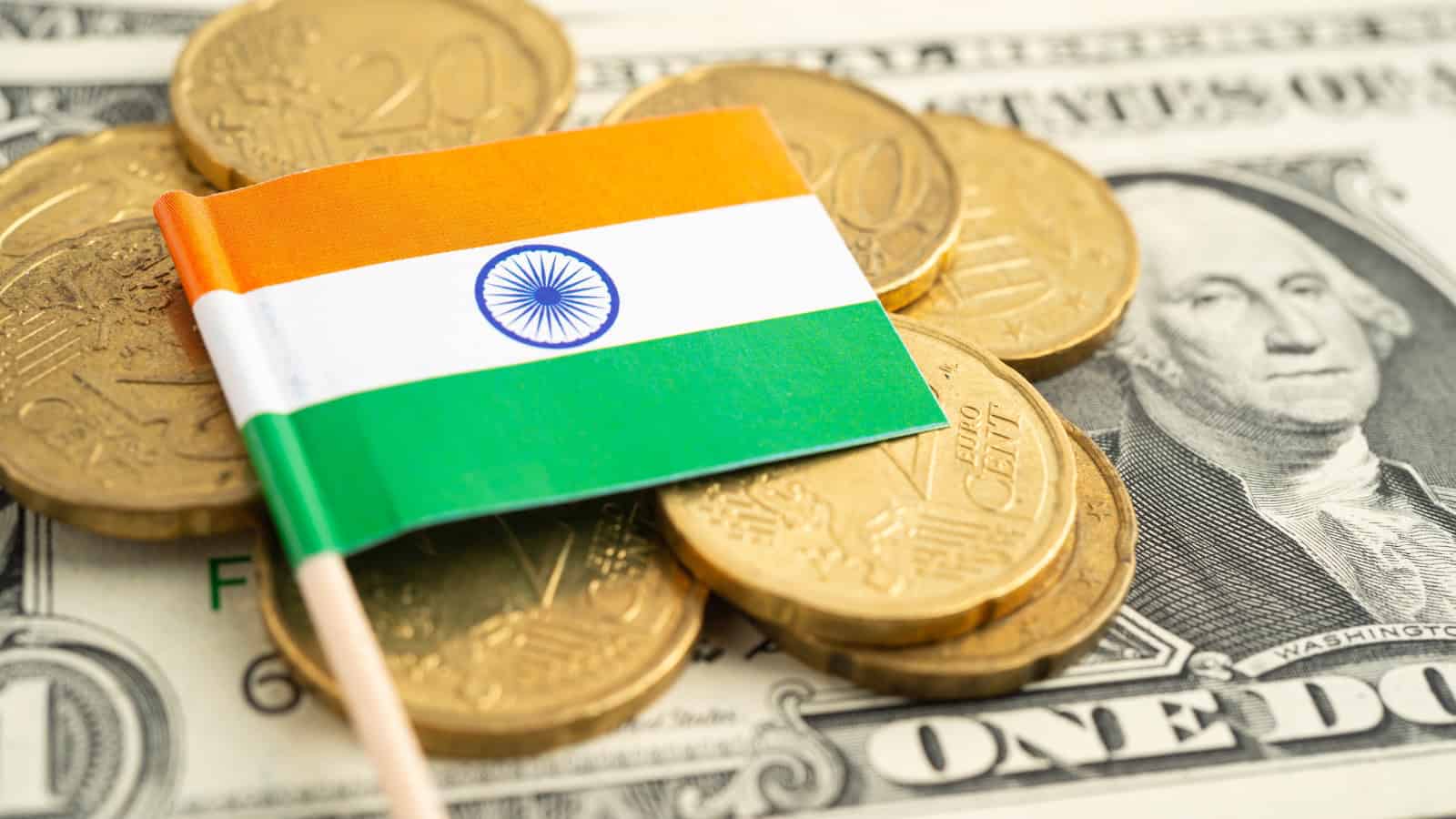 India flag on coins and dollar bills, illustrating currency exchange and economic fluctuations.