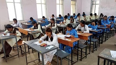 Students taking Telangana SSC exams with OMR sheets in a classroom setting.