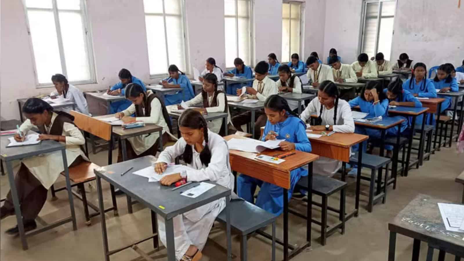 Students taking Telangana SSC exams with OMR sheets in a classroom setting.