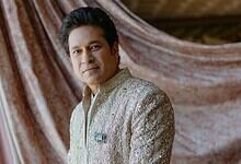 Close-up of Sachin Tendulkar wearing a detailed elephant-shaped brooch on his traditional attire.