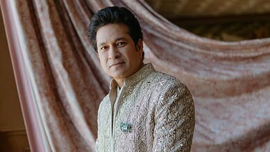 Close-up of Sachin Tendulkar wearing a detailed elephant-shaped brooch on his traditional attire.