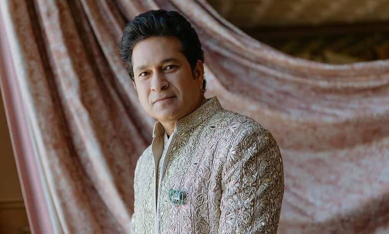 Close-up of Sachin Tendulkar wearing a detailed elephant-shaped brooch on his traditional attire.