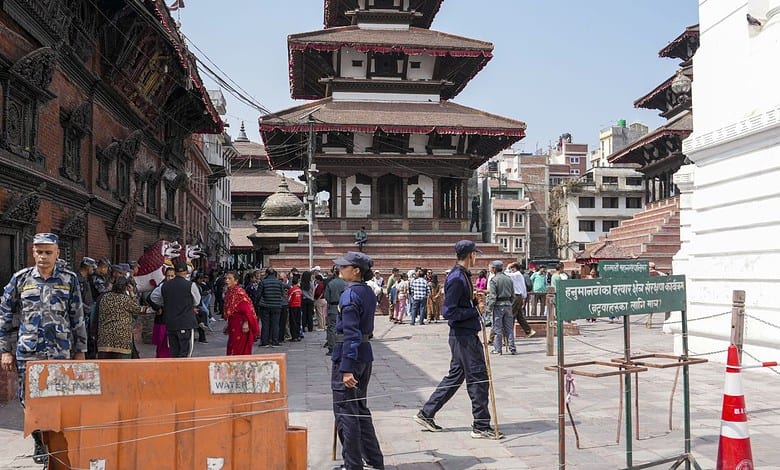 Nepal election polling station with security personnel and voters.