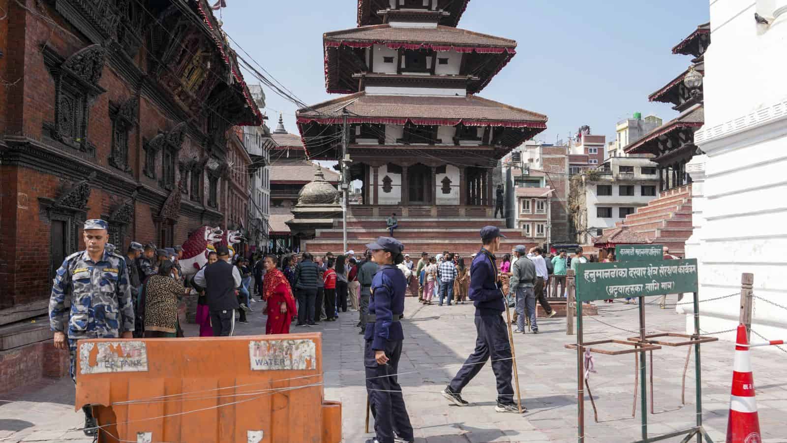Nepal election polling station with security personnel and voters.