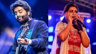 Arijit Singh and Shreya Ghoshal singing on stage during a concert.