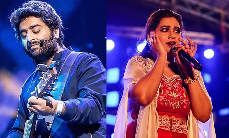 Arijit Singh and Shreya Ghoshal singing on stage during a concert.