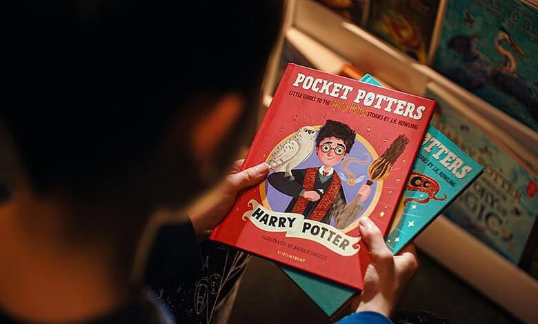 Child holding 'Pocket Potters' book from Blooming India’s new series at a bookstore.