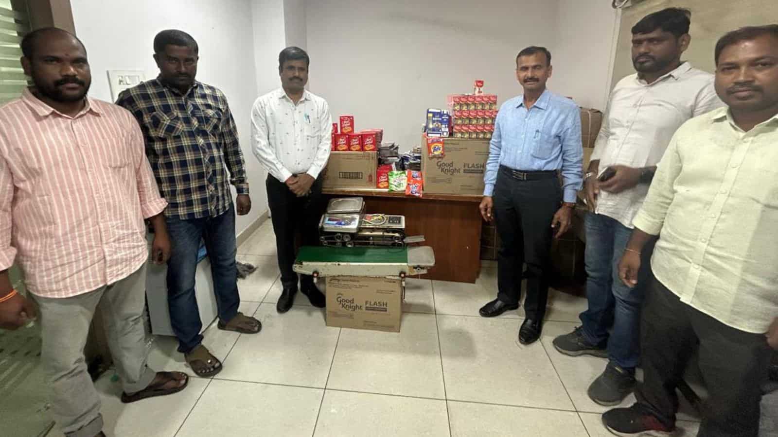Hyderabad police display seized packets of counterfeit tea and detergent.