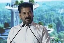 Revanth Reddy speaking at a public event about the Musi Development Plan Report, emphasizing political st.