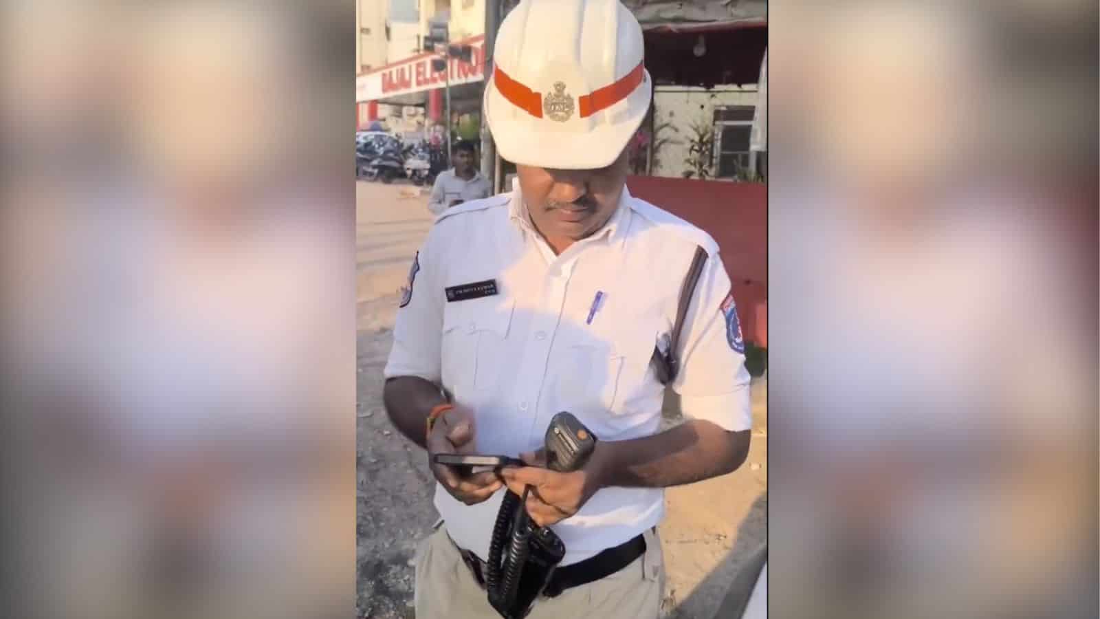 Traffic police officer in uniform using a mobile phone during duty.