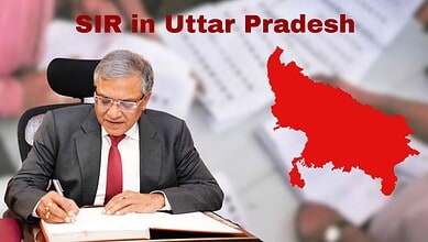 An official in Uttar Pradesh managing claim forms related to the SIR process, highlighting the large volu.