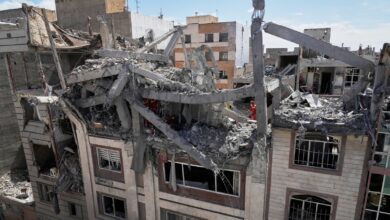 First responders inspect a residential building hit in an earlier US-Israeli strike in Tehran on Friday, March 27.