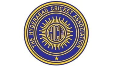 Hyderabad Cricket Association emblem with HCA initials and sunburst design.