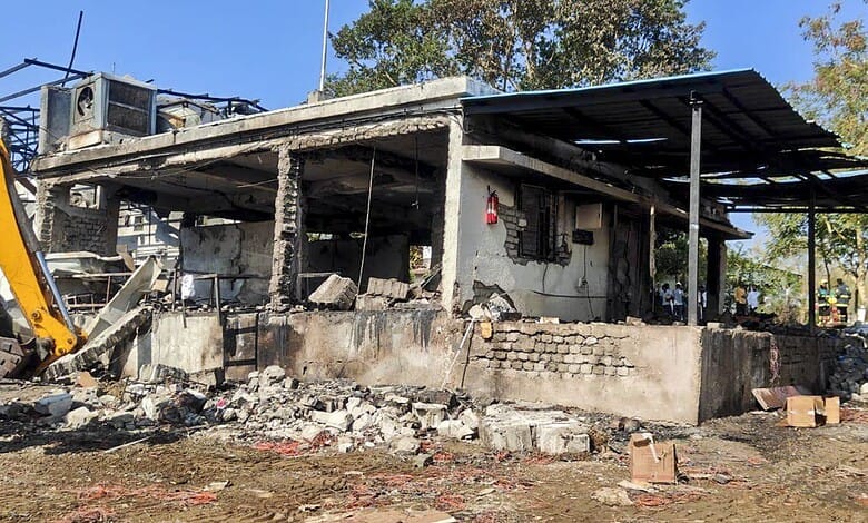 Damaged factory building in Nagpur following a tragic blast, with debris and destruction visible.