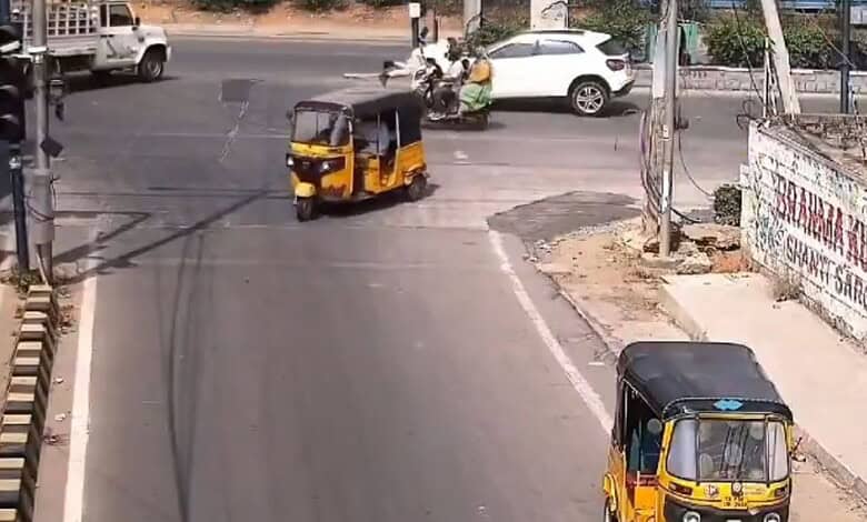 Drunk driver dragging traffic cop on bonnet at Gachibowli intersection in Hyderabad.