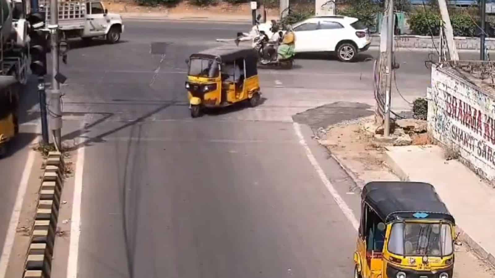Drunk driver dragging traffic cop on bonnet at Gachibowli intersection in Hyderabad.