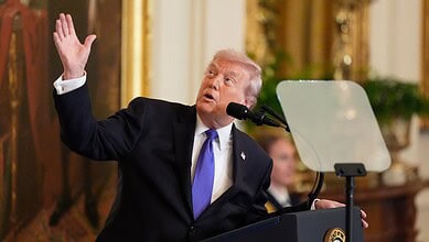 Donald Trump speaking at a podium during a press conference.