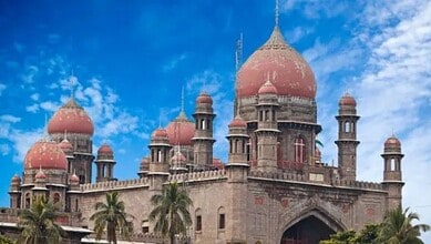Historic Kaleshwaram palace with domes and minarets under a blue sky, surrounded by palm trees.