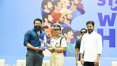 Police officer receiving an award at The Siasat Daily event promoting women's safety.