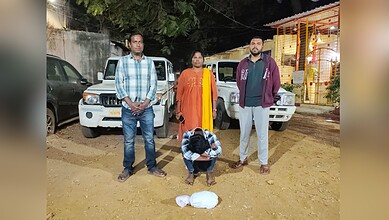 Arrested individual with police officers and seized ganja in Dhoolpet, Hyderabad, during a drug bust oper.