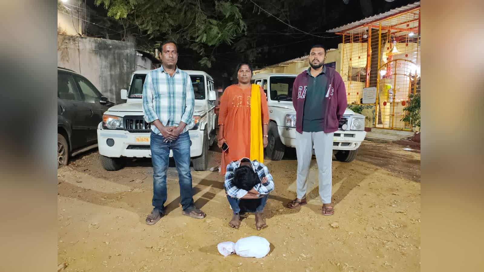 Arrested individual with police officers and seized ganja in Dhoolpet, Hyderabad, during a drug bust oper.