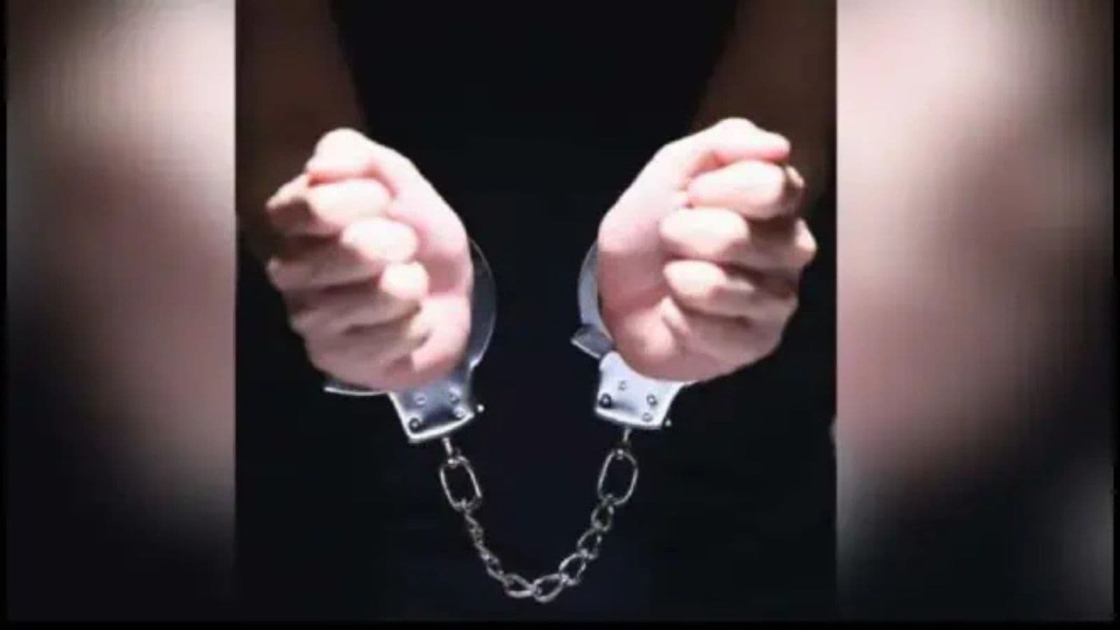 Hands in handcuffs, symbolising arrest and detention.