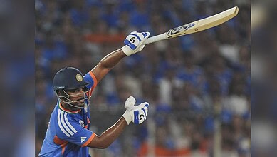 India cricket player hitting a six with a bat during the T20 World Cup final.