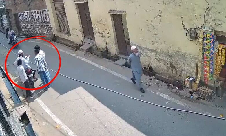 Hate crime in UP: group of people gathered on the street, with one individual walking away, underlining s.