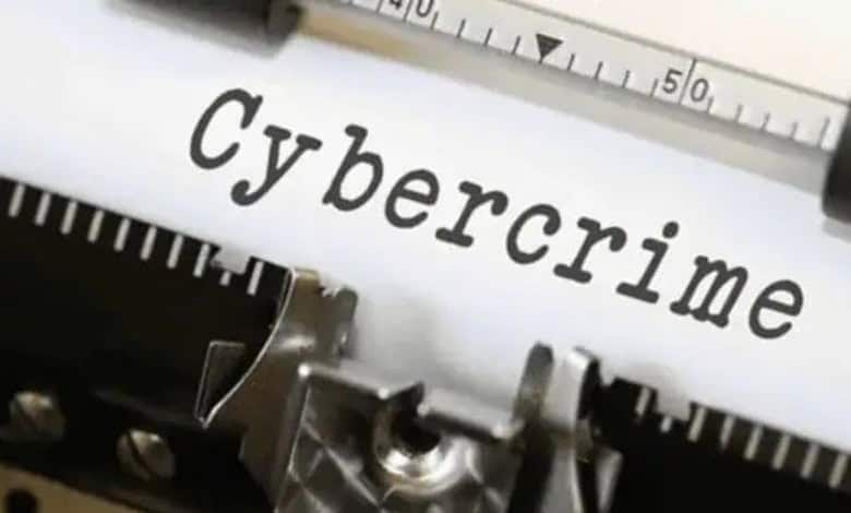 Close-up of the word "Cybercrime" on paper with a ruler and typewriter.