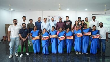 Team of professionals receiving awards at The Siasat Daily event in a conference room.