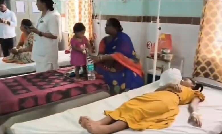 Hospital scene with children and a woman attending to a patient in a yellow dress.