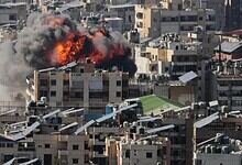 Explosion in Tehran cityscape with smoke and fire amid urban buildings.