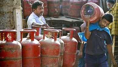 Man carrying LPG cylinder during panic buying amid Middle East conflict in Bengaluru.