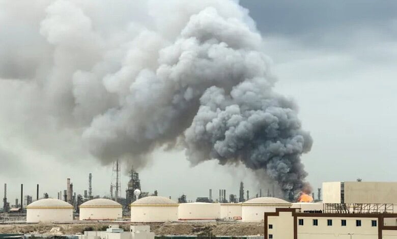 Refinery emitting thick smoke amid industrial operations.