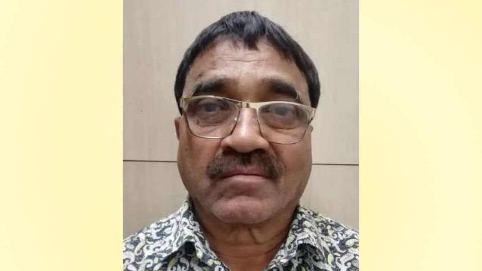 Man with glasses and patterned shirt, close-up portrait for The Siasat Daily.