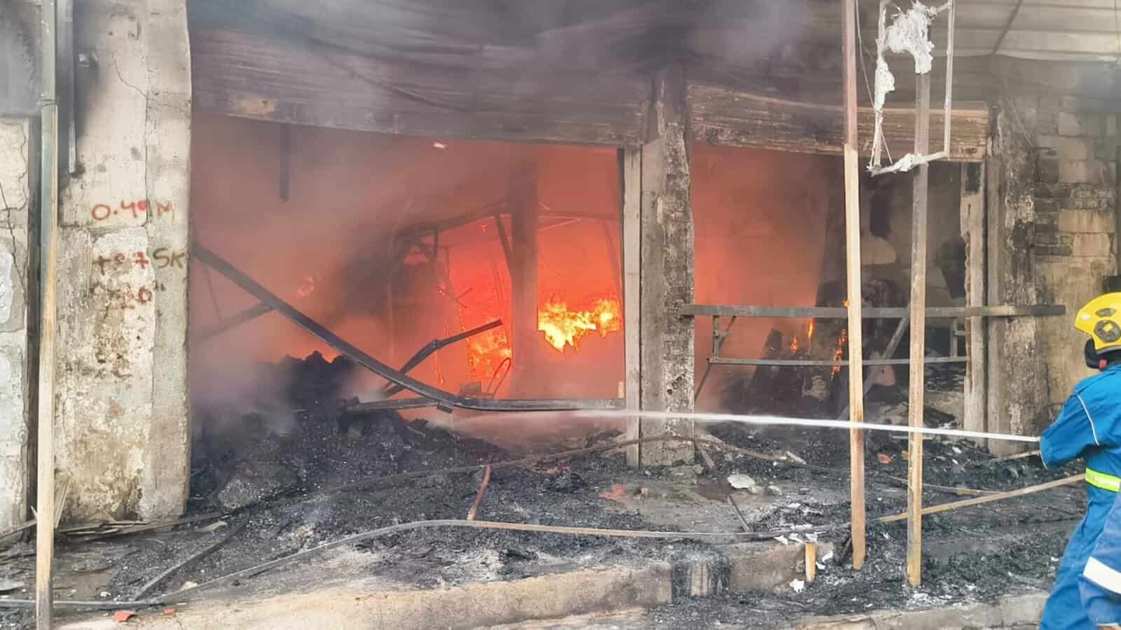 Fire engulfing a building near Farooq Nagar bus stand in Falaknuma, with firefighters responding to the b.