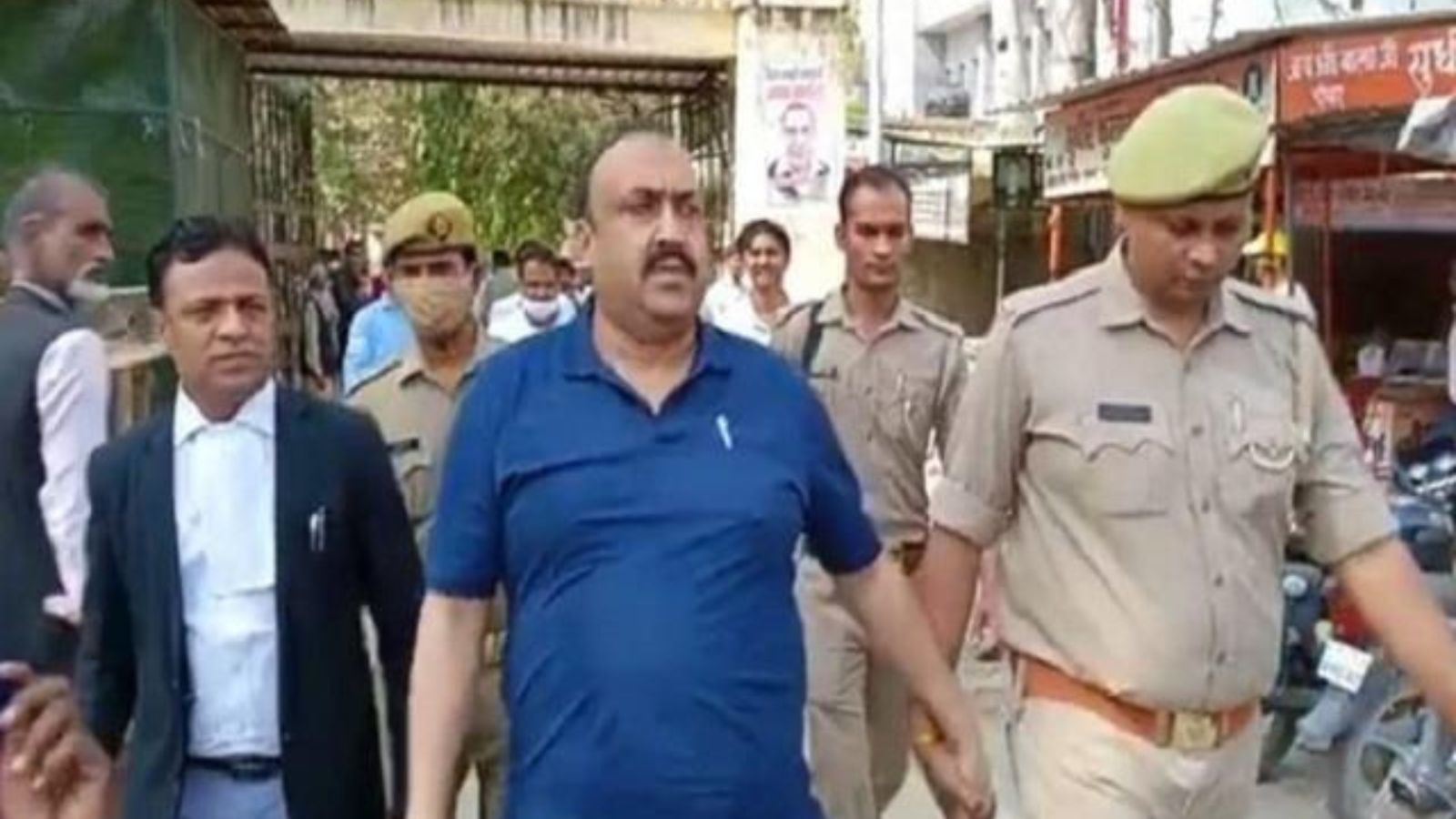 SP leader Yusuf Malik escorted by the police