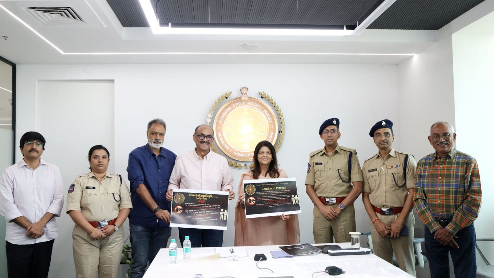 Group photo of officials unveiling new film piracy prevention guidelines in Telangana.