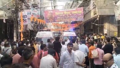 People gather outside building in Delhi