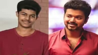 Young man with short black hair and a smile, wearing a maroon shirt, in a casual setting.