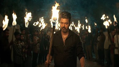 Vijay leads a torchlight march to address rumours, surrounded by supporters holding torches at night.