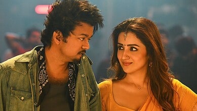 Vijay and Trisha looking at each other on set, capturing a moment of emotional connection.