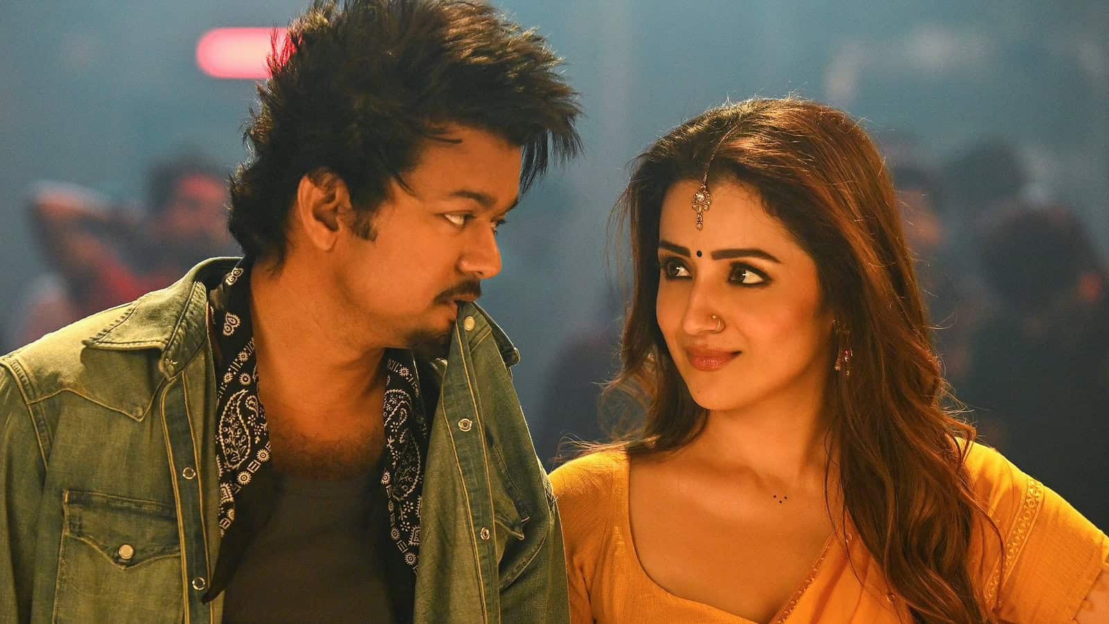 Vijay and Trisha looking at each other on set, capturing a moment of emotional connection.