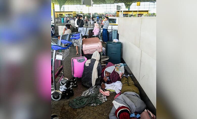 Kochi: Passengers wait below the flight information display at Cochin International Airport after several international flights were cancelled amid disruptions linked to the Iran-Israel conflict, in Kochi, Sunday, March 01, 2026. (PTI Photo)