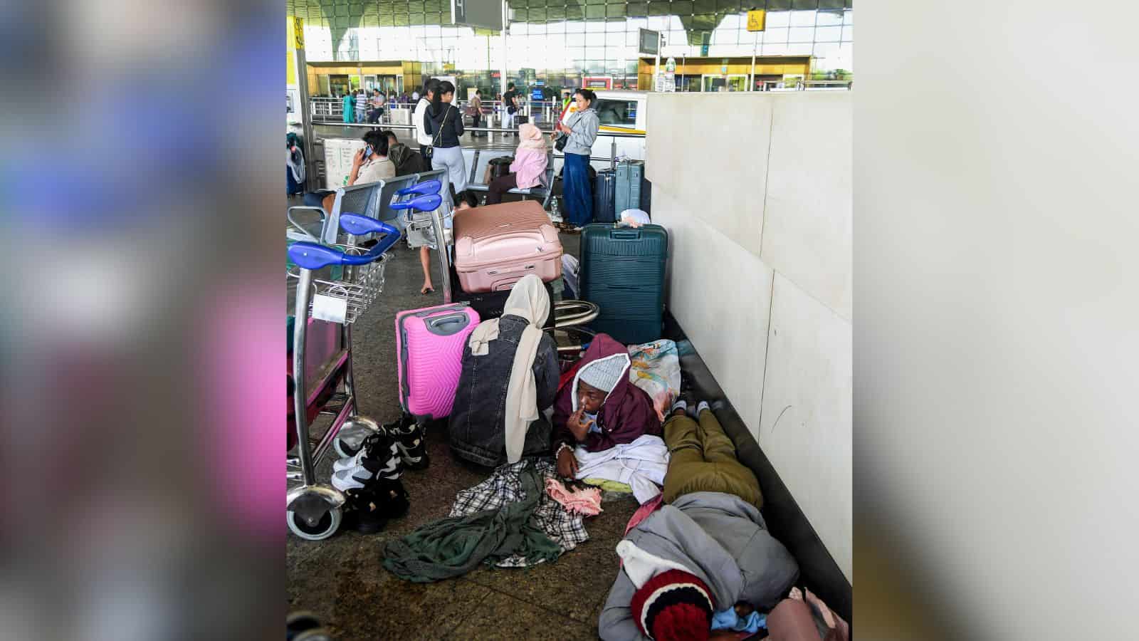 Kochi: Passengers wait below the flight information display at Cochin International Airport after several international flights were cancelled amid disruptions linked to the Iran-Israel conflict, in Kochi, Sunday, March 01, 2026. (PTI Photo)