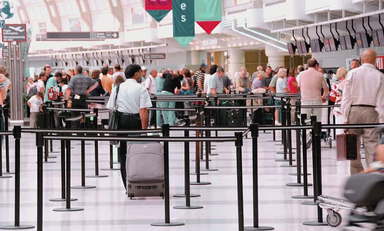 Indian travellers waiting in long queues at airport due to US-Israel strikes on Iran.