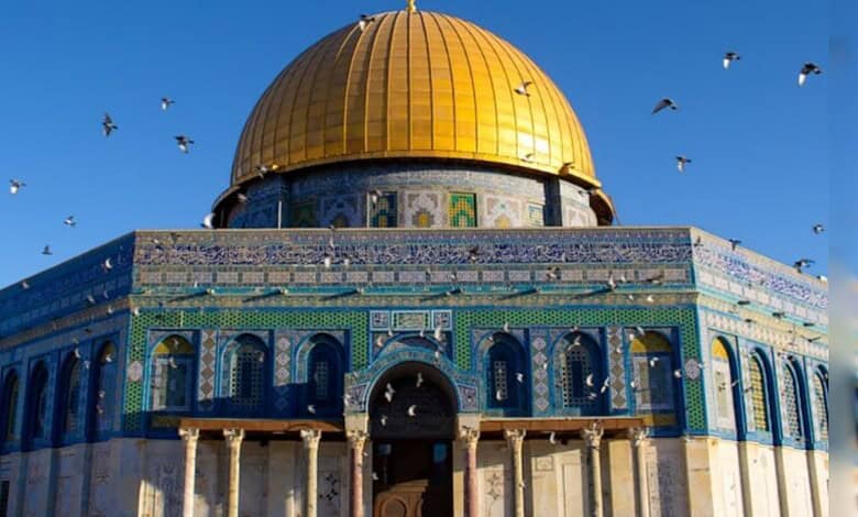 View of Al-Aqsa Mosque with golden dome and blue tile exterior in Jerusalem.