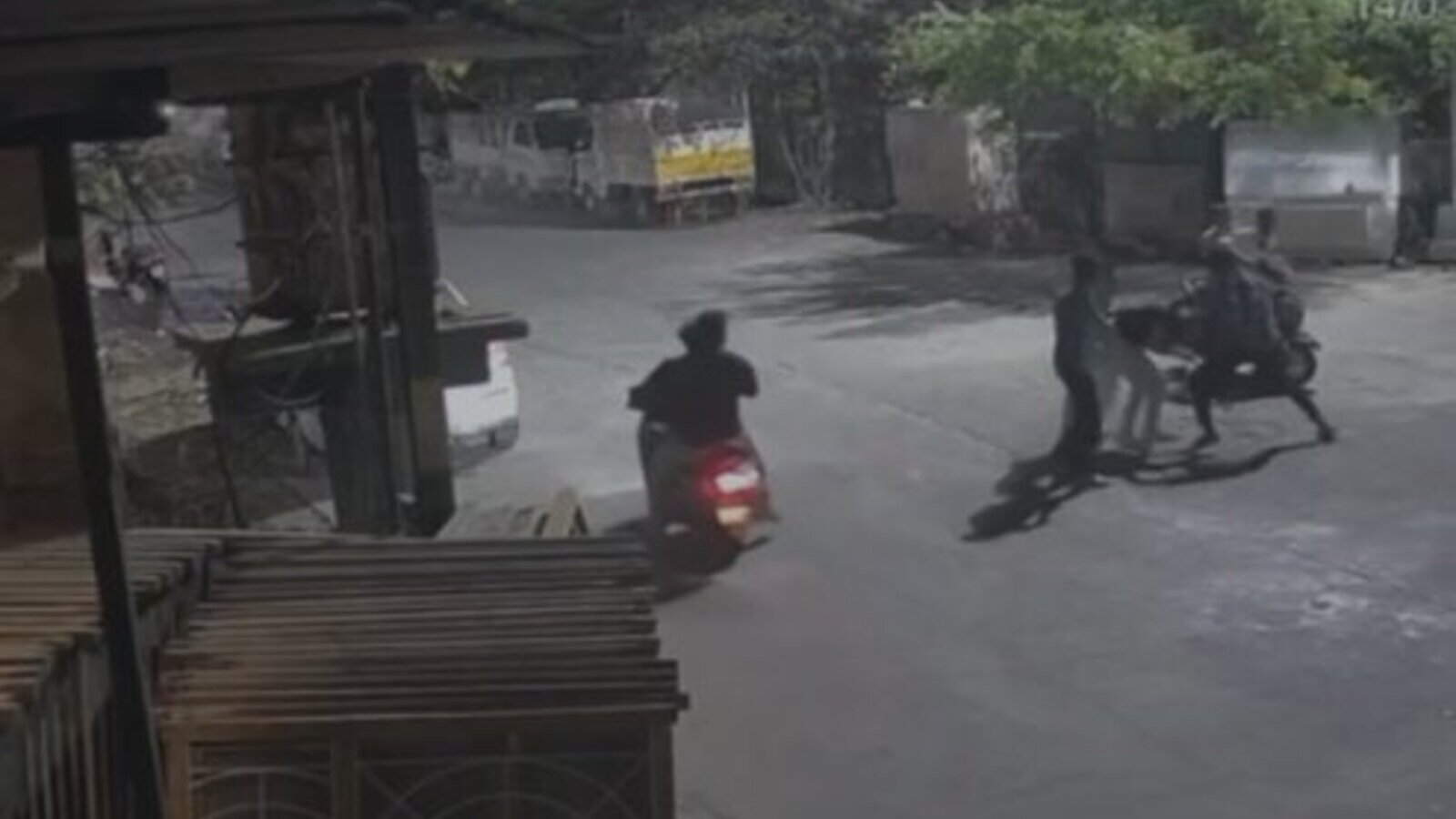 Young men on scooters and pedestrians creating disorder on the street in Warangal’s Mills Colony.