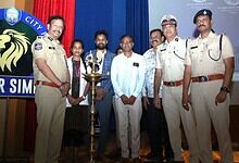 Police officers and volunteers at Hyderabad cybercrime awareness event.