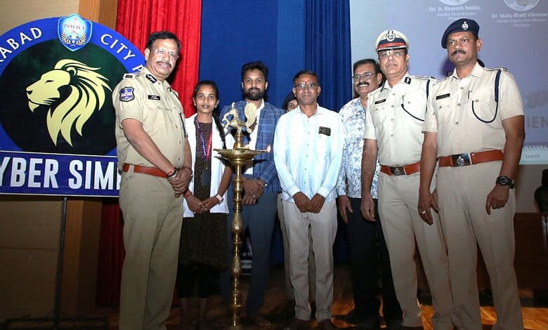 Police officers and volunteers at Hyderabad cybercrime awareness event.